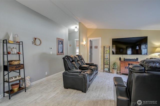 living area with baseboards, wood finished floors, and vaulted ceiling