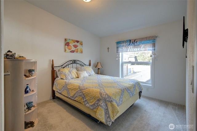 bedroom with carpet and vaulted ceiling