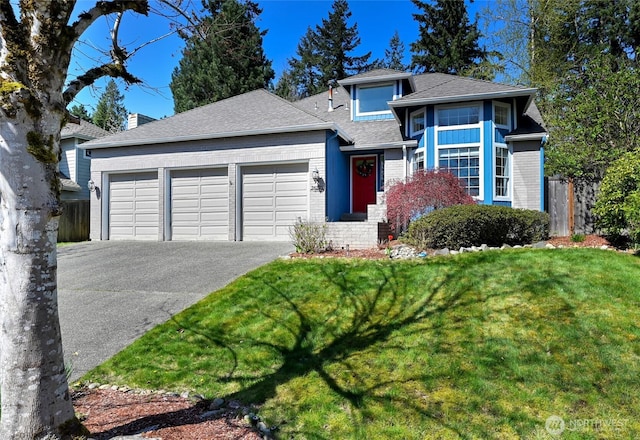 26225 Lake Wilderness Country Club Dr SE, Maple Valley, WA 98038 - view of front facade featuring a garage, aphalt driveway, fence, a front yard, and roof with shingles