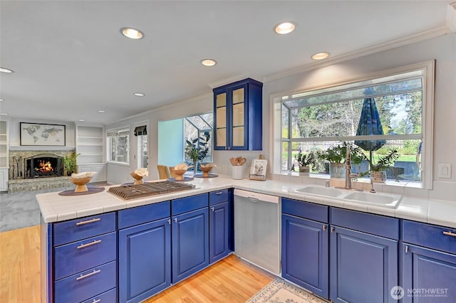 26225 Lake Wilderness Country Club Dr SE, Maple Valley, WA 98038 - kitchen featuring a peninsula, open floor plan, glass insert cabinets, appliances with stainless steel finishes, and ornamental molding