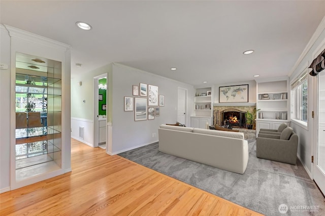 26225 Lake Wilderness Country Club Dr SE, Maple Valley, WA 98038 - living area with visible vents, recessed lighting, wood finished floors, a warm lit fireplace, and ornamental molding