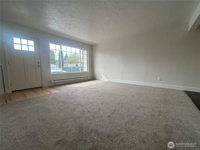 unfurnished living room featuring carpet floors, baseboards, a textured ceiling, a baseboard heating unit, and tile patterned floors