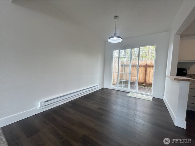 unfurnished dining area with baseboards, a baseboard heating unit, and dark wood finished floors