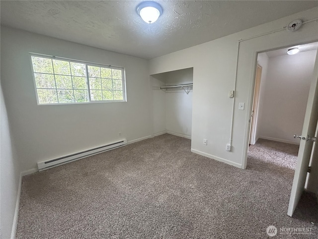 unfurnished bedroom with carpet flooring, a textured ceiling, baseboards, a baseboard heating unit, and a closet