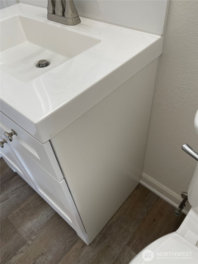 bathroom featuring baseboards and wood finished floors