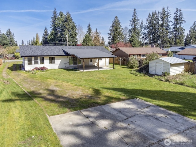 back of house with a patio, an outdoor structure, a yard, and a storage shed