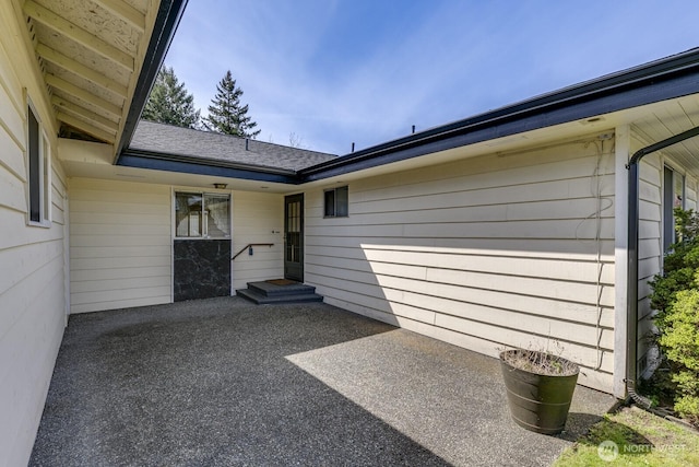 view of exterior entry featuring a patio