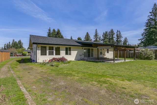 exterior space with a patio, a yard, and fence