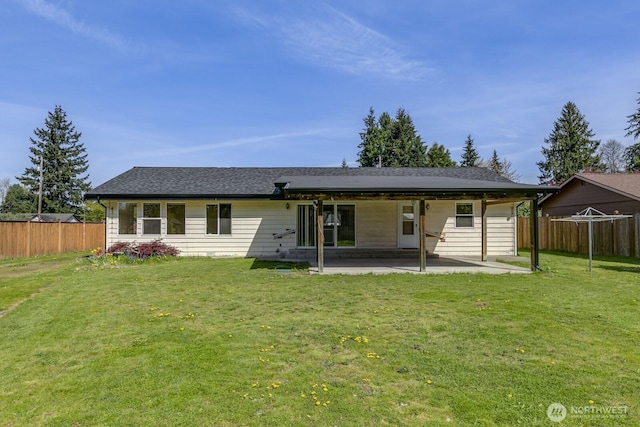 back of house with fence, a yard, and a patio area