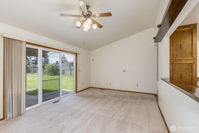 empty room with baseboards, visible vents, a ceiling fan, and light colored carpet