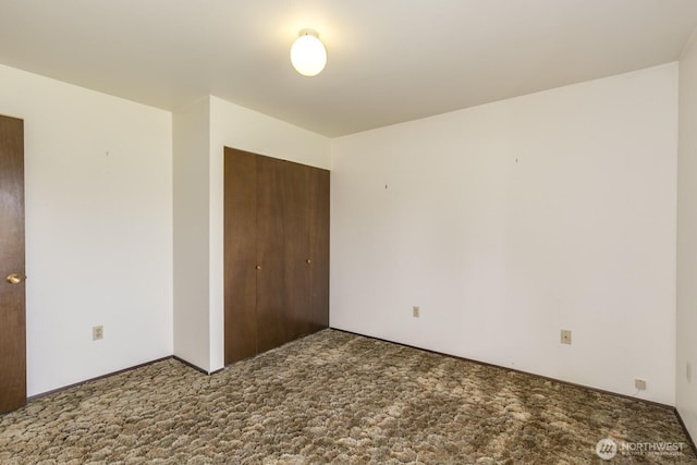 unfurnished bedroom featuring a closet and carpet floors