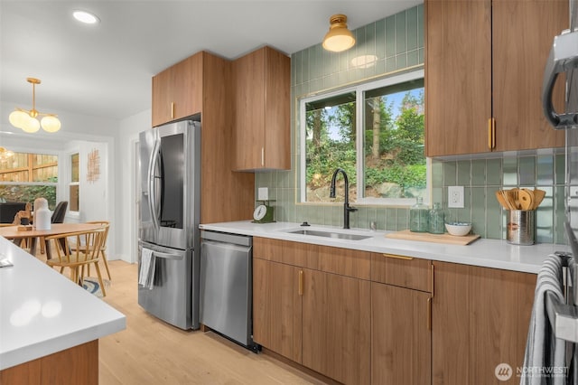 107 219th Pl SE, Bothell, WA 98021 - kitchen featuring a sink, brown cabinetry, stainless steel appliances, light countertops, and light wood-style floors