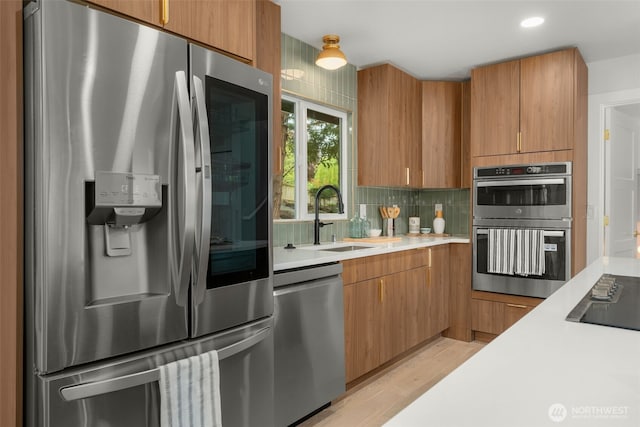 107 219th Pl SE, Bothell, WA 98021 - kitchen featuring light wood finished floors, light countertops, tasteful backsplash, and appliances with stainless steel finishes