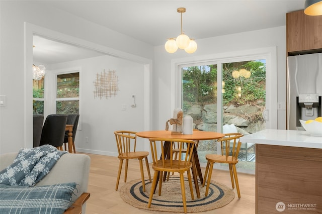 107 219th Pl SE, Bothell, WA 98021 - dining room featuring an inviting chandelier, light wood-style floors, and baseboards