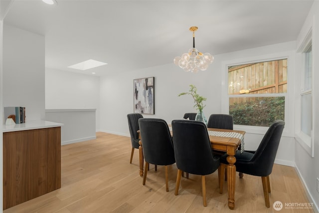 107 219th Pl SE, Bothell, WA 98021 - dining area featuring a skylight, recessed lighting, a notable chandelier, baseboards, and light wood-style floors