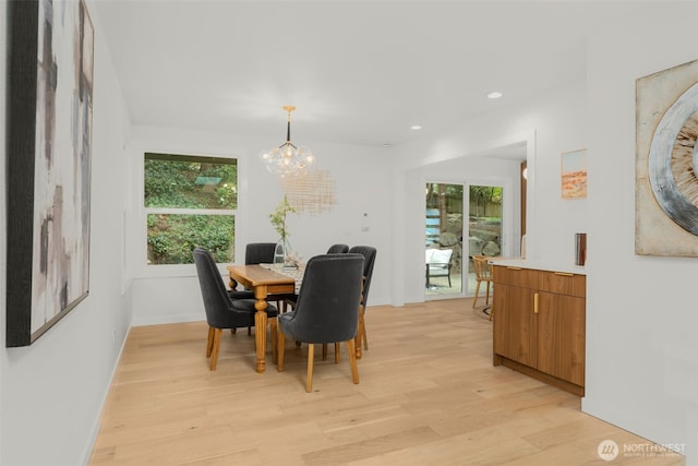 107 219th Pl SE, Bothell, WA 98021 - dining room featuring light wood finished floors, baseboards, a healthy amount of sunlight, and a notable chandelier