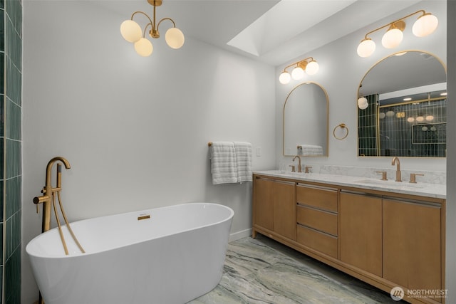 107 219th Pl SE, Bothell, WA 98021 - bathroom featuring marble finish floor, a soaking tub, double vanity, and a sink