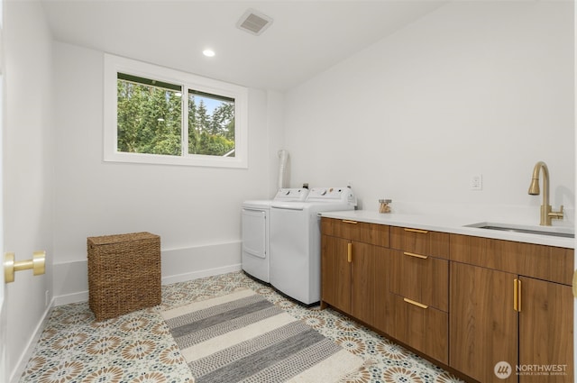107 219th Pl SE, Bothell, WA 98021 - washroom with baseboards, visible vents, a sink, separate washer and dryer, and cabinet space