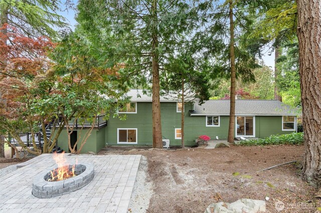 107 219th Pl SE, Bothell, WA 98021 - rear view of house with an outdoor fire pit, a wooden deck, and a patio