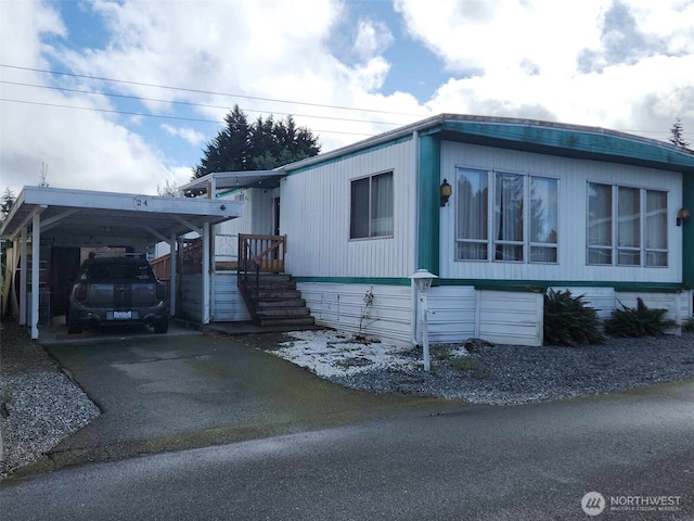 manufactured / mobile home with an attached carport and driveway