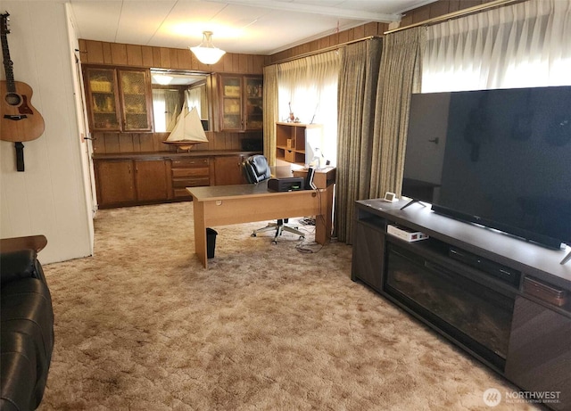 office space with light colored carpet and wooden walls