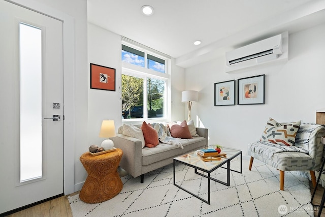 living room with recessed lighting, wood finished floors, and a wall unit AC