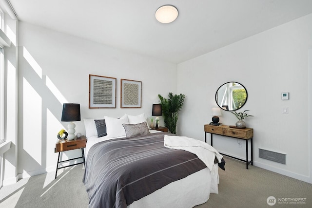 carpeted bedroom with baseboards and visible vents