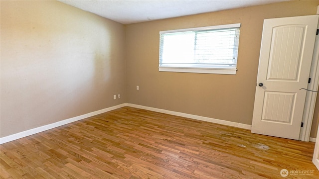 2125 N Highland St, Tacoma, WA 98406 - spare room featuring baseboards and wood finished floors