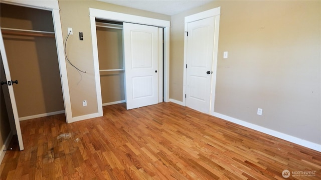 2125 N Highland St, Tacoma, WA 98406 - unfurnished bedroom featuring wood finished floors and baseboards