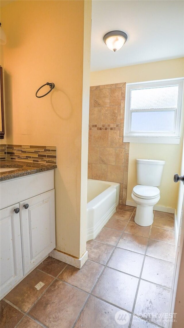 2125 N Highland St, Tacoma, WA 98406 - full bathroom with vanity, baseboards, tile patterned floors, toilet, and a washtub