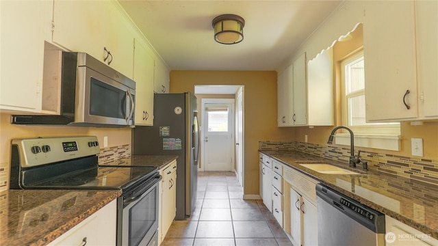 2125 N Highland St, Tacoma, WA 98406 - kitchen featuring a sink, light tile patterned floors, decorative backsplash, and stainless steel appliances