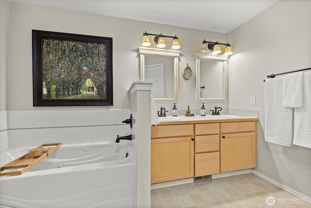 full bath featuring a bath, baseboards, a sink, and double vanity
