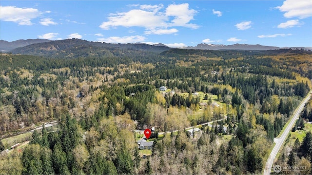 drone / aerial view with a forest view and a mountain view