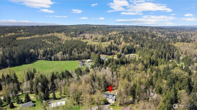 drone / aerial view featuring a forest view