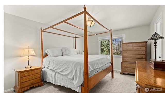 carpeted bedroom featuring baseboards