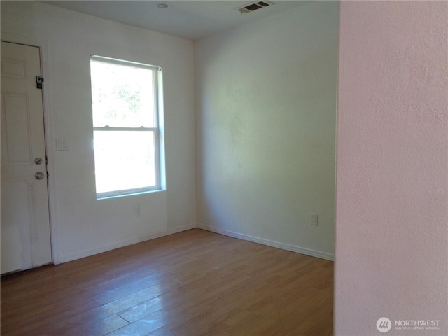 5 Orchard Loop N, Tonasket, WA 98855 - unfurnished room featuring baseboards, plenty of natural light, light wood-type flooring, and visible vents