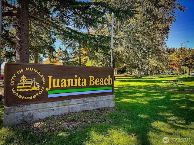 community sign featuring a lawn