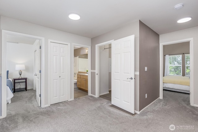 1231 148th Pl SE, Mill Creek, WA 98012 - unfurnished bedroom featuring light colored carpet, baseboards, and ensuite bath