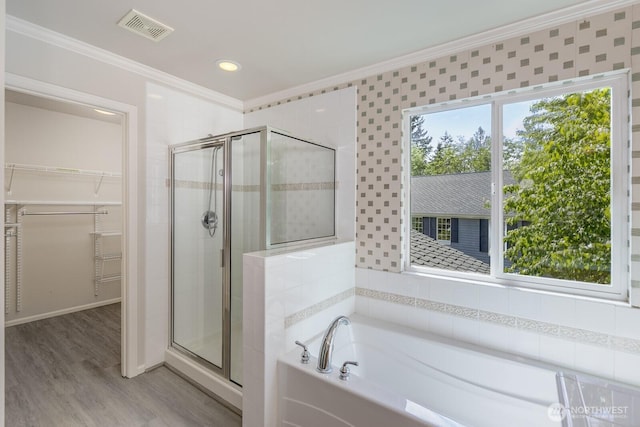 1231 148th Pl SE, Mill Creek, WA 98012 - full bath featuring ornamental molding, a bath, a stall shower, a spacious closet, and wood finished floors