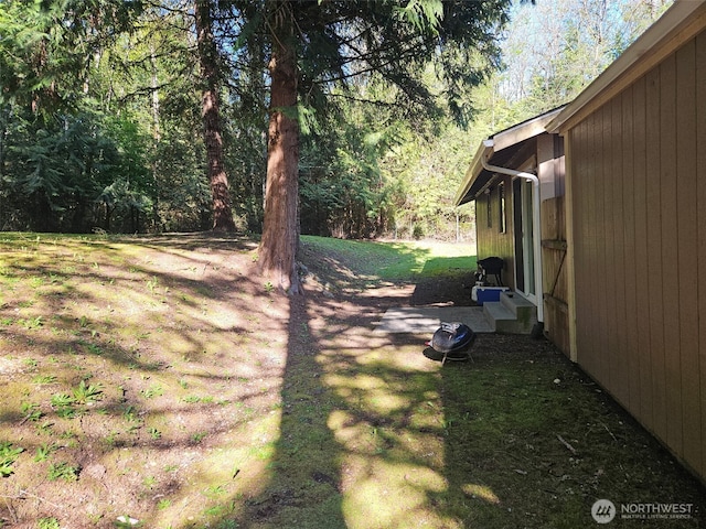 view of yard featuring a view of trees