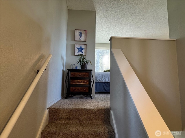 4751 State Route 109, Moclips, WA 98562 - staircase featuring carpet flooring, a textured ceiling, and a textured wall