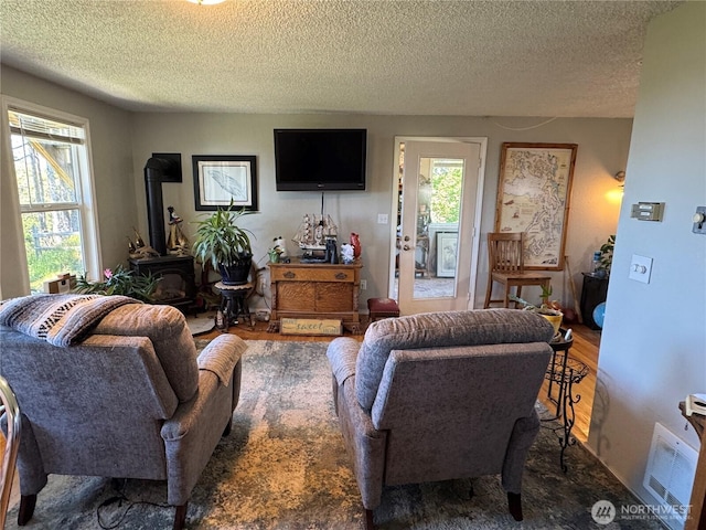 4751 State Route 109, Moclips, WA 98562 - living area featuring a wood stove and a textured ceiling