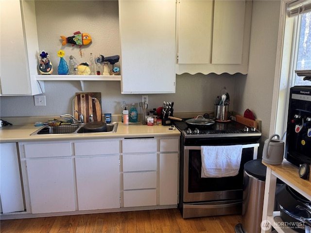4751 State Route 109, Moclips, WA 98562 - kitchen featuring stainless steel electric range, a sink, light countertops, white cabinets, and light wood finished floors