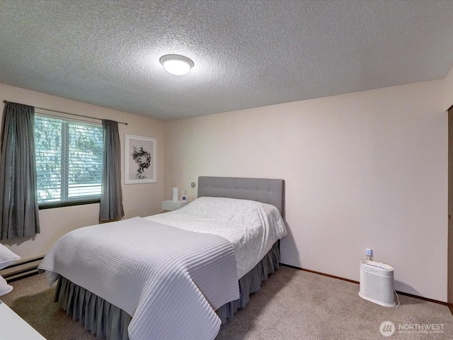 bedroom with carpet floors, a textured ceiling, and baseboards