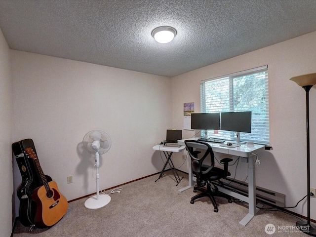 office area featuring baseboards, a textured ceiling, and light colored carpet