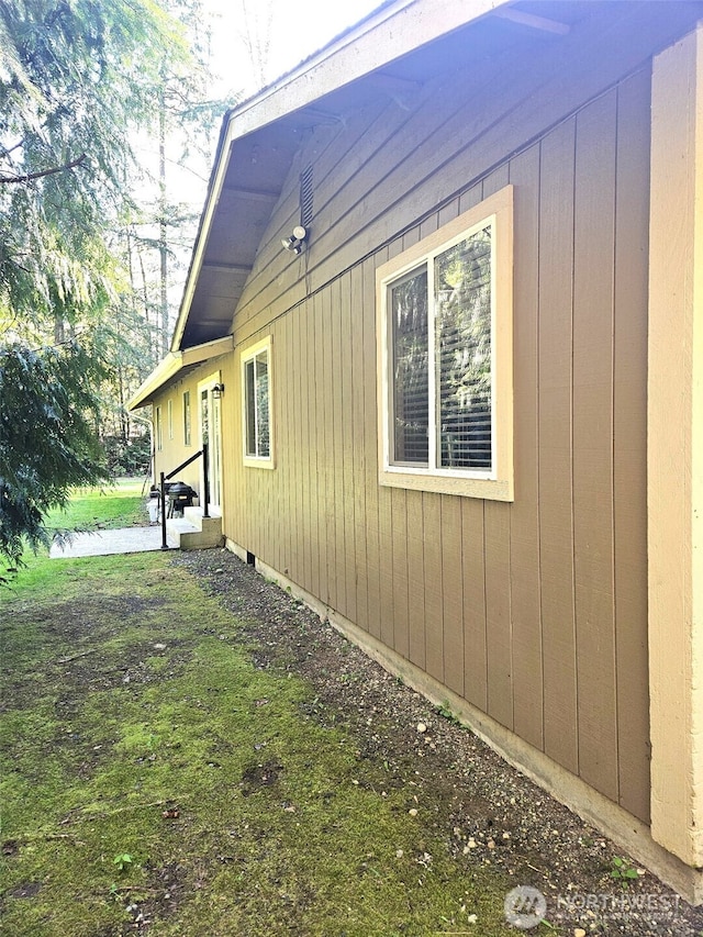 view of side of home featuring entry steps