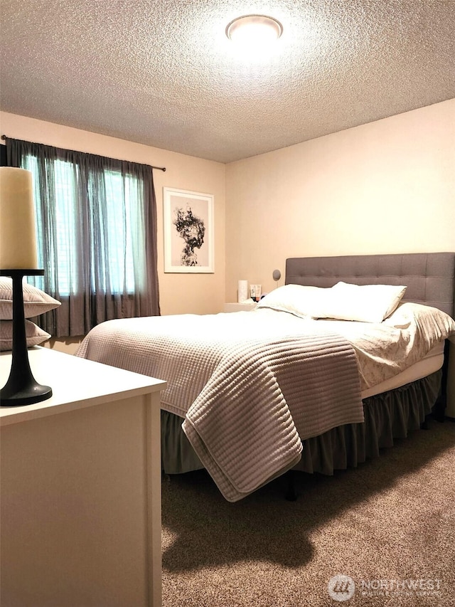 bedroom with carpet flooring and a textured ceiling