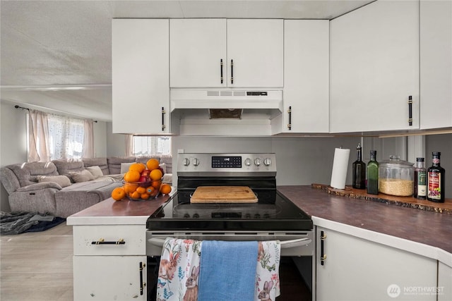 kitchen featuring white cabinets, under cabinet range hood, open floor plan, and stainless steel electric range oven