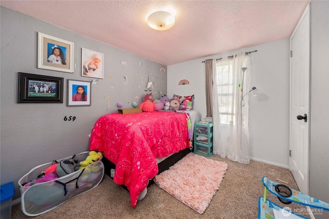 carpeted bedroom featuring a textured ceiling and baseboards