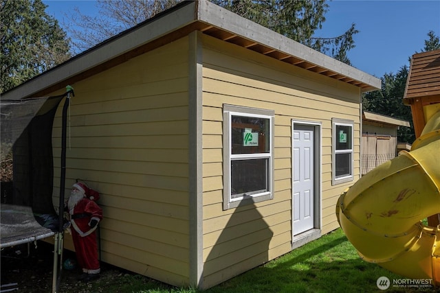 view of outbuilding with a trampoline